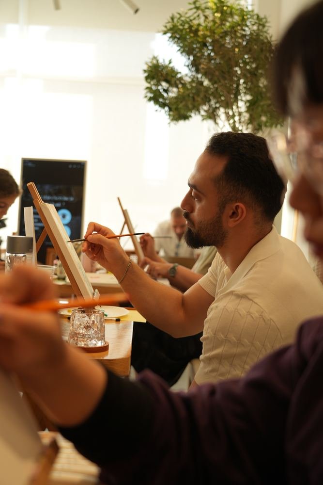 A man painting at an easel